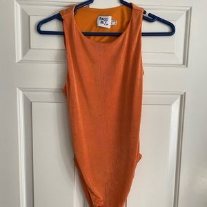 Orange shimmery body suit with open back